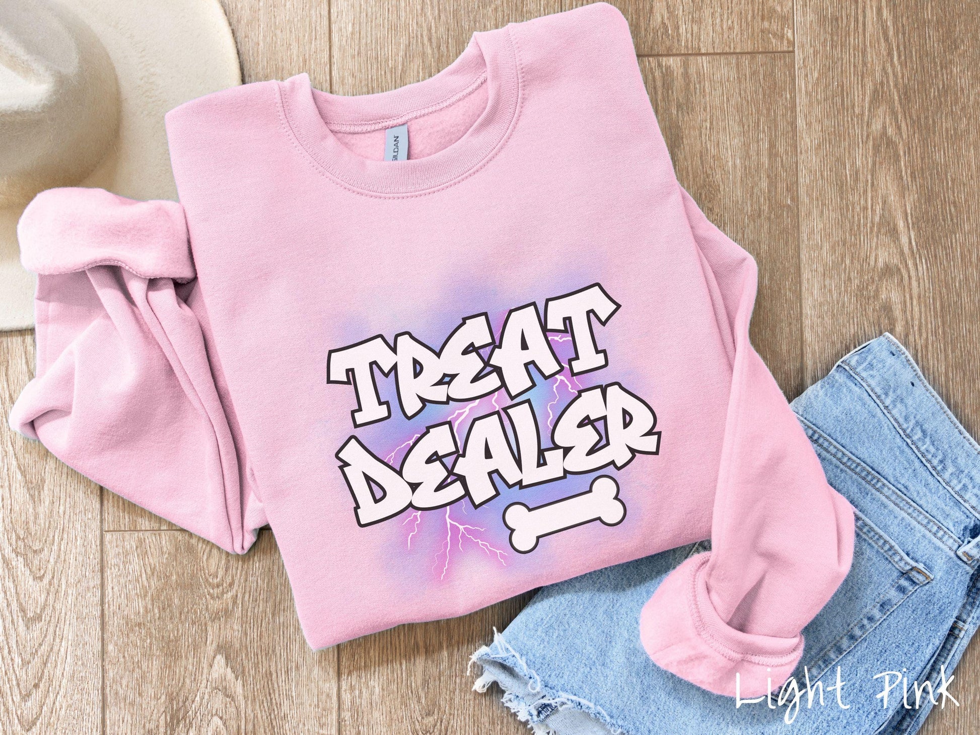 A vintage Gildan sweatshirt for dog lovers who always have treats on hand! Featuring the playful text Treat Dealer in graffiti-style white font, this design makes a fun statement for pet parents, dog trainers, and anyone who spoils their pup.