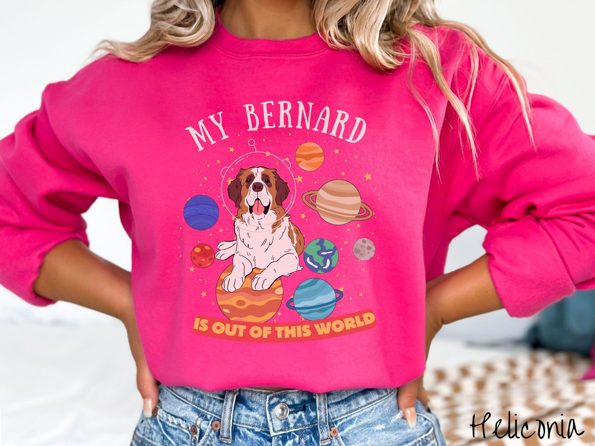 A vintage Gildan sweatshirt featuring the text 'My Bernard is Out of This World'. The design showcases an adorable St. Bernard sitting proudly atop Jupiter, surrounded by a vibrant solar system filled with colorful planets and twinkling stars.