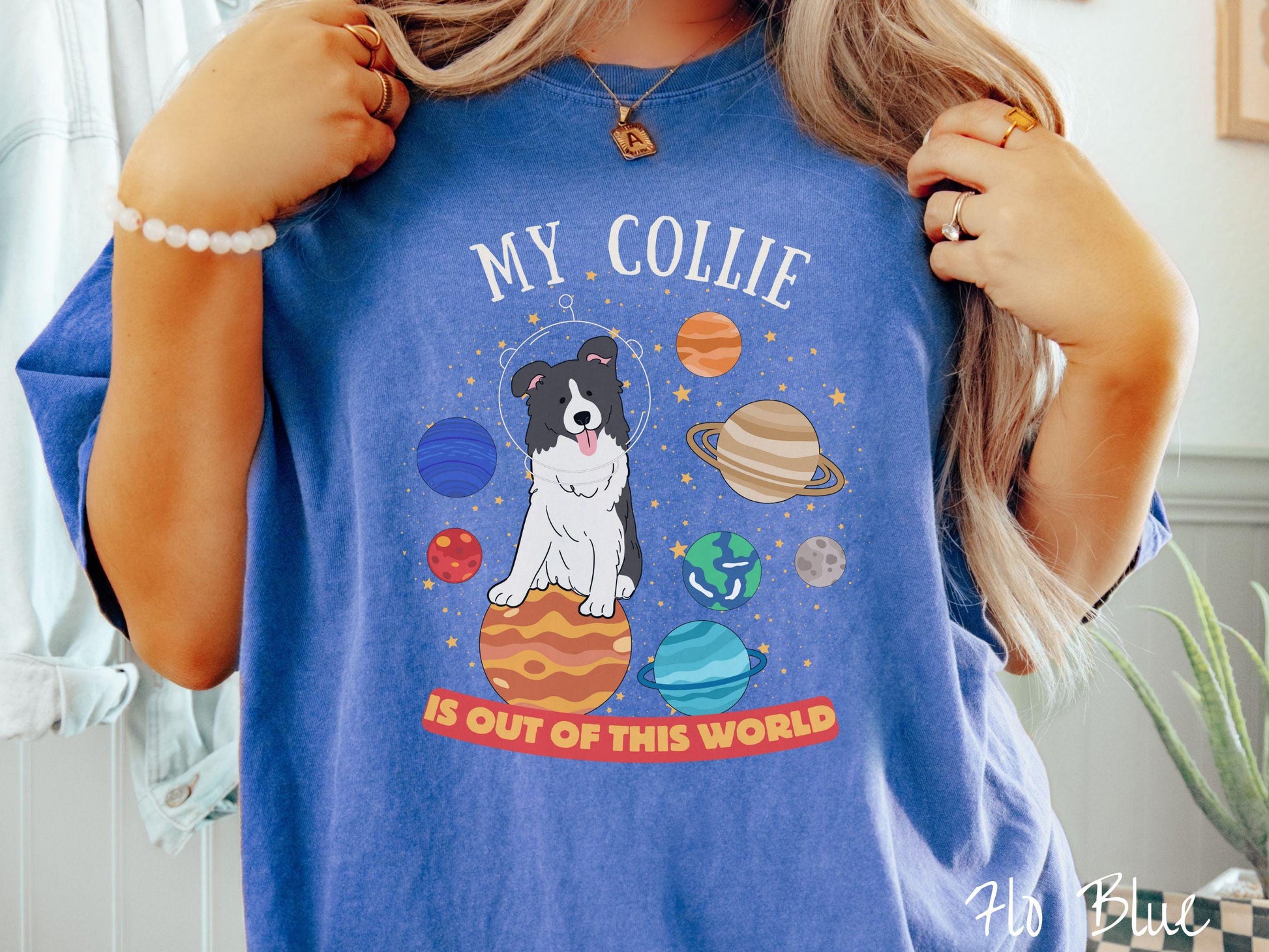 A vintage Comfort Colors t-shirt featuring the text My Collie is Out of This World. The design showcases an adorable Border Collie sitting proudly atop Jupiter, surrounded by a vibrant solar system filled with colorful planets and twinkling stars.
