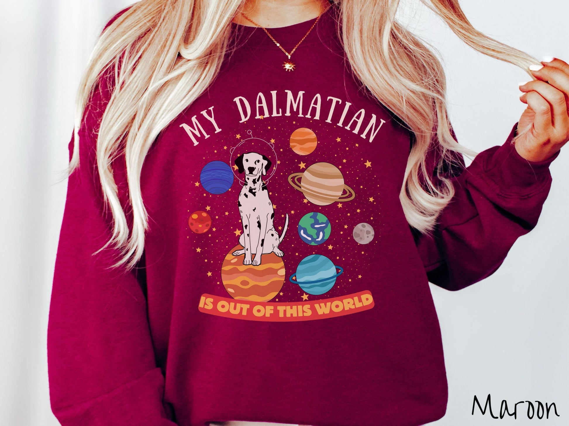 A vintage Gildan sweatshirt featuring the text My Dalmation is Out of This World. The design showcases a Dalmation sitting proudly atop Jupiter, surrounded by a vibrant solar system filled with colorful planets and twinkling stars.