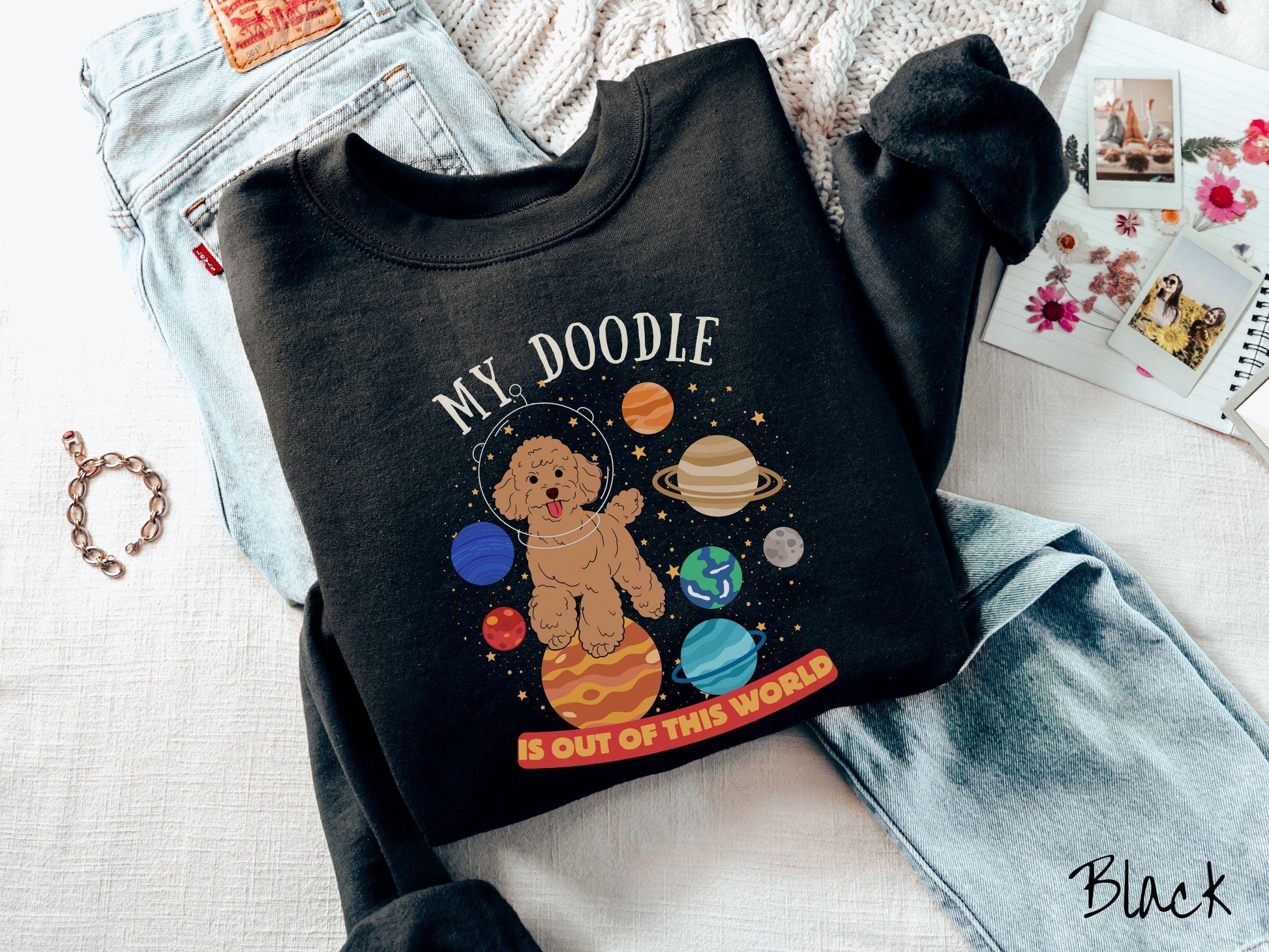 A vintage Gildan sweatshirt featuring the text My Doodle is Out of This World. The design showcases a German Shepherd sitting proudly atop Jupiter, surrounded by a vibrant solar system filled with colorful planets and twinkling stars.
