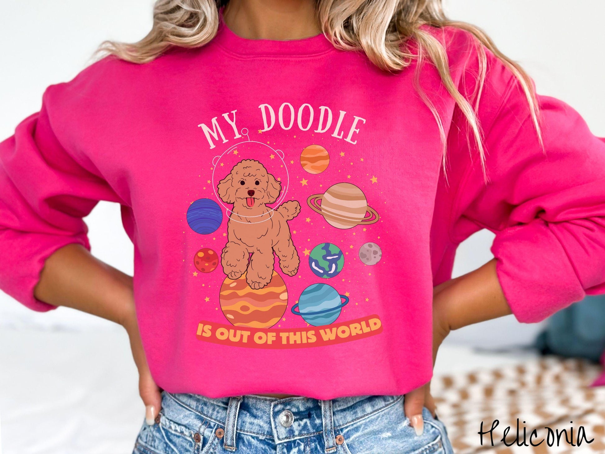A vintage Gildan sweatshirt featuring the text My Doodle is Out of This World. The design showcases a German Shepherd sitting proudly atop Jupiter, surrounded by a vibrant solar system filled with colorful planets and twinkling stars.