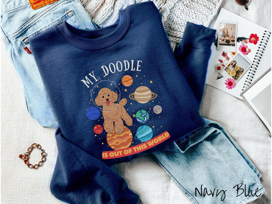 A vintage Gildan sweatshirt featuring the text My Doodle is Out of This World. The design showcases a German Shepherd sitting proudly atop Jupiter, surrounded by a vibrant solar system filled with colorful planets and twinkling stars.