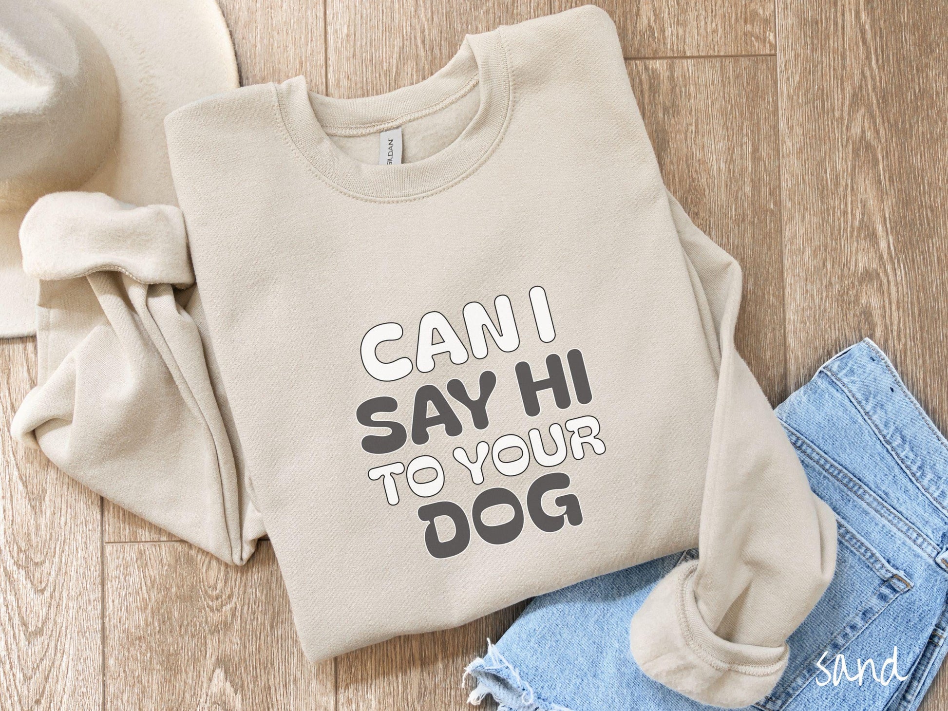 This vintage Gildan sweatshirt is perfect for dog lovers who want to make a bold statement. Featuring the text &quot;CAN I SAY HI TO YOUR DOG&quot; in uppercase black and white font, this sweater combines comfort and style with a playful message.