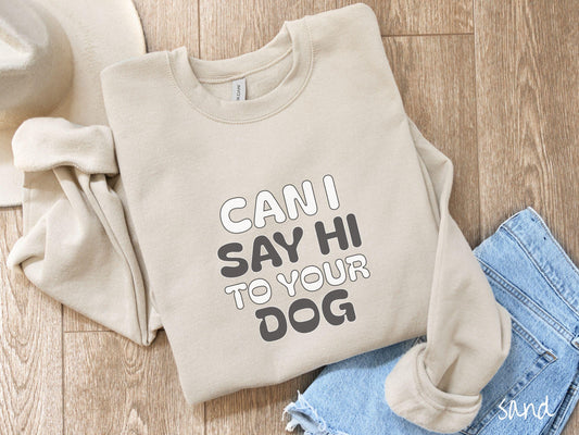 This vintage Gildan sweatshirt is perfect for dog lovers who want to make a bold statement. Featuring the text &quot;CAN I SAY HI TO YOUR DOG&quot; in uppercase black and white font, this sweater combines comfort and style with a playful message.