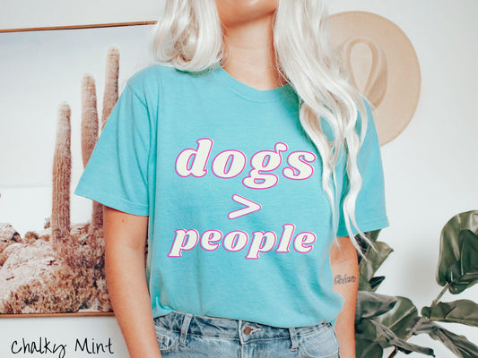 A vintage Comfort Colors t-shirt is perfect for dog lovers who know that dogs are greater than people! Featuring the funny saying Dogs &gt; People, this tee is a must-have for anyone who prefers the company of their furry friends over humans.