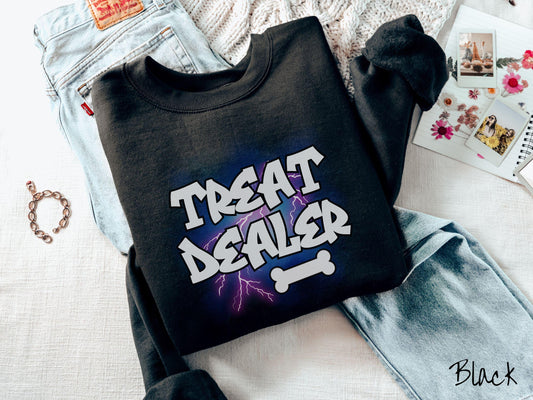 A vintage Gildan sweatshirt for dog lovers who always have treats on hand! Featuring the playful text Treat Dealer in graffiti-style white font, this design makes a fun statement for pet parents, dog trainers, and anyone who spoils their pup.